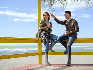 Image showing young couple drinking beer together at the beach