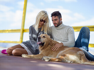 Image showing Couple with dog enjoying time on beach