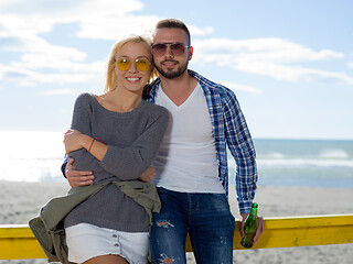 Image showing young couple drinking beer together at the beach