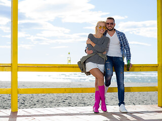 Image showing young couple drinking beer together at the beach