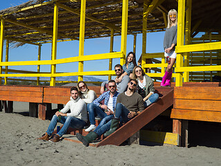 Image showing Group of friends having fun on autumn day at beach