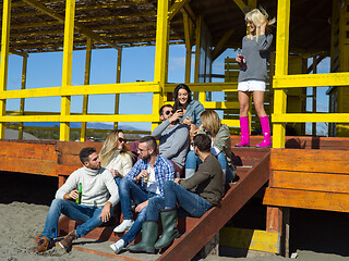 Image showing Group of friends having fun on autumn day at beach