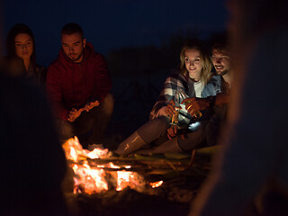 Image showing Couple enjoying with friends at night on the beach