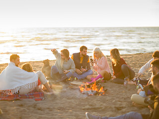 Image showing Friends having fun at beach on autumn day