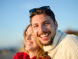 Image showing couple on a beach at autumn sunny day