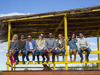 Image showing Group of friends having fun on autumn day at beach