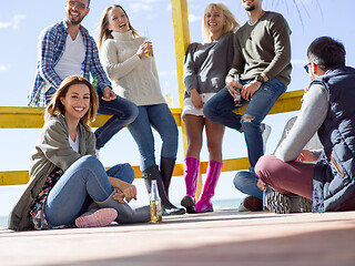 Image showing Group of friends having fun on autumn day at beach