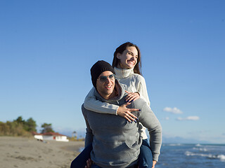 Image showing couple having fun at beach during autumn