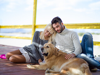 Image showing Couple with dog enjoying time on beach