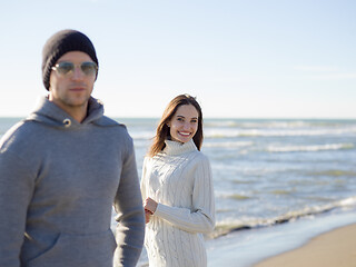 Image showing Loving young couple on a beach at autumn sunny day