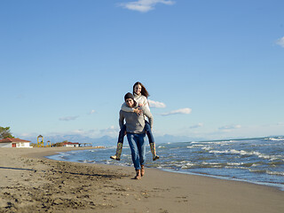 Image showing couple having fun at beach during autumn