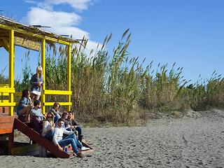 Image showing Group of friends having fun on autumn day at beach