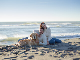 Image showing Couple with dog enjoying time on beach