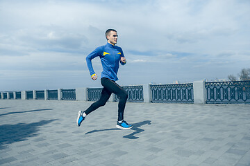 Image showing Man running on city background at morning.