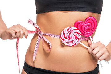 Image showing woman abdomen with measuring tape