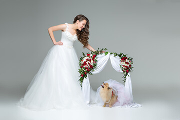 Image showing bride girl with dog bride under flower arch