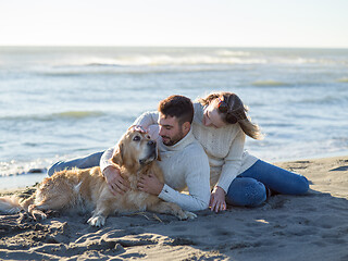 Image showing Couple with dog enjoying time on beach