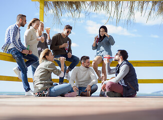 Image showing Group of friends having fun on autumn day at beach