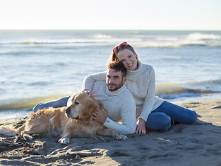 Image showing Couple with dog enjoying time on beach