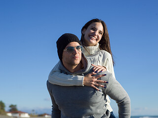 Image showing couple having fun at beach during autumn