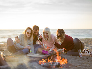 Image showing Friends having fun at beach on autumn day