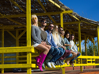 Image showing Group of friends having fun on autumn day at beach