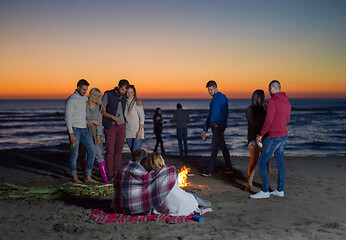 Image showing Friends having fun at beach on autumn day