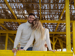 Image showing young couple drinking beer together at the beach