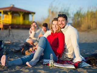Image showing couple on a beach at autumn sunny day