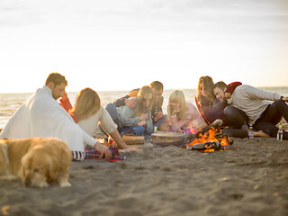 Image showing Friends having fun at beach on autumn day