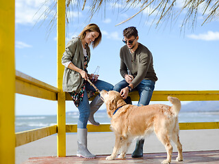 Image showing young couple drinking beer together at the beach