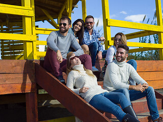 Image showing Group of friends having fun on autumn day at beach