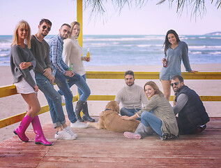 Image showing Group of friends having fun on autumn day at beach