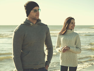 Image showing Loving young couple on a beach at autumn sunny day