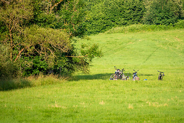 Image showing A few bicycles in the meadow