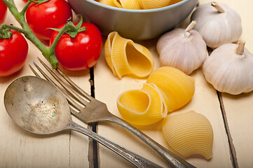 Image showing Italian snail lumaconi pasta with tomatoes