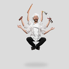 Image showing Cooker, chef, baker in uniform multitask like shiva isolated on gray studio background