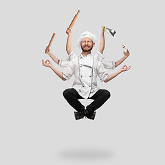 Image showing Cooker, chef, baker in uniform multitask like shiva isolated on gray studio background