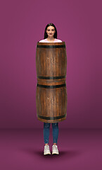 Image showing Tall high woman and long barrel isolated on purple studio background. Unusual delighted and long