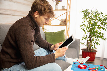 Image showing Man reading message, greetings for New Year and Christmas 2021 from friends or family with his tablet