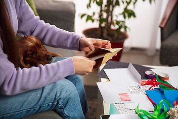 Image showing Woman opening, recieving greeting card for New Year and Christmas 2021 from friends or family