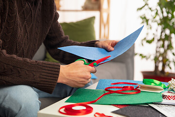 Image showing Man making greeting card for New Year and Christmas 2021 for friends or family, scrap booking, DIY