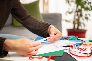 Image showing Man making greeting card for New Year and Christmas 2021 for friends or family, scrap booking, DIY