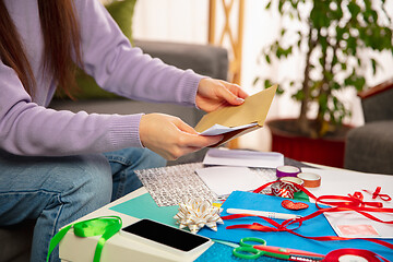 Image showing Woman making greeting card for New Year and Christmas 2021 for friends or family, scrap booking, DIY