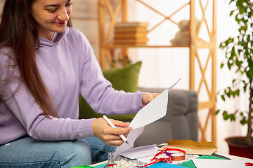 Image showing Woman writing letter, greeting card for New Year and Christmas 2021 for friends or family