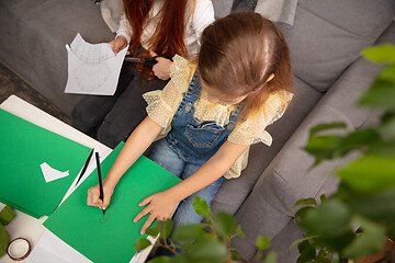 Image showing Two little children, girls together in creativity of the house. Happy kids make handmade toys for games or New Year celebration