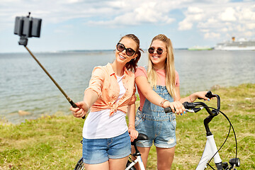 Image showing teenage girls with bicycle taking selfie in summer