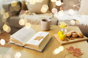 Image showing book, lemon, tea and cookies on table at home
