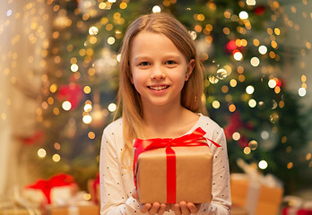 Image showing smiling girl with christmas gift at home