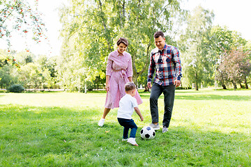 Image showing happy family playing soccer at summer park